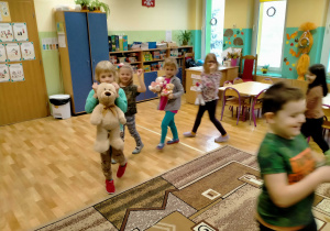 Dzieci ustawione w "pociąg", poruszają się ze swoimi misiami po sali, przy piosence "Jedzie pociąg...".