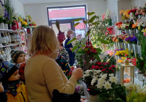 Pani florystka prezentuje dzieciom kwiat-hiacynt.